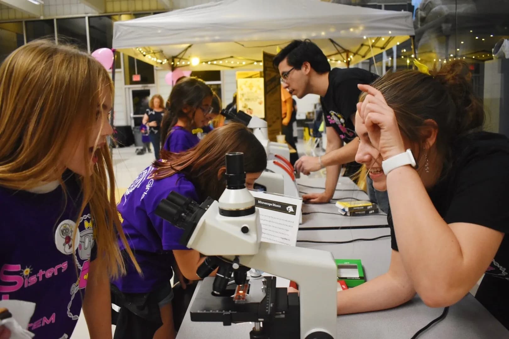 SiS volunteer amazing young girl with STEM experiment.